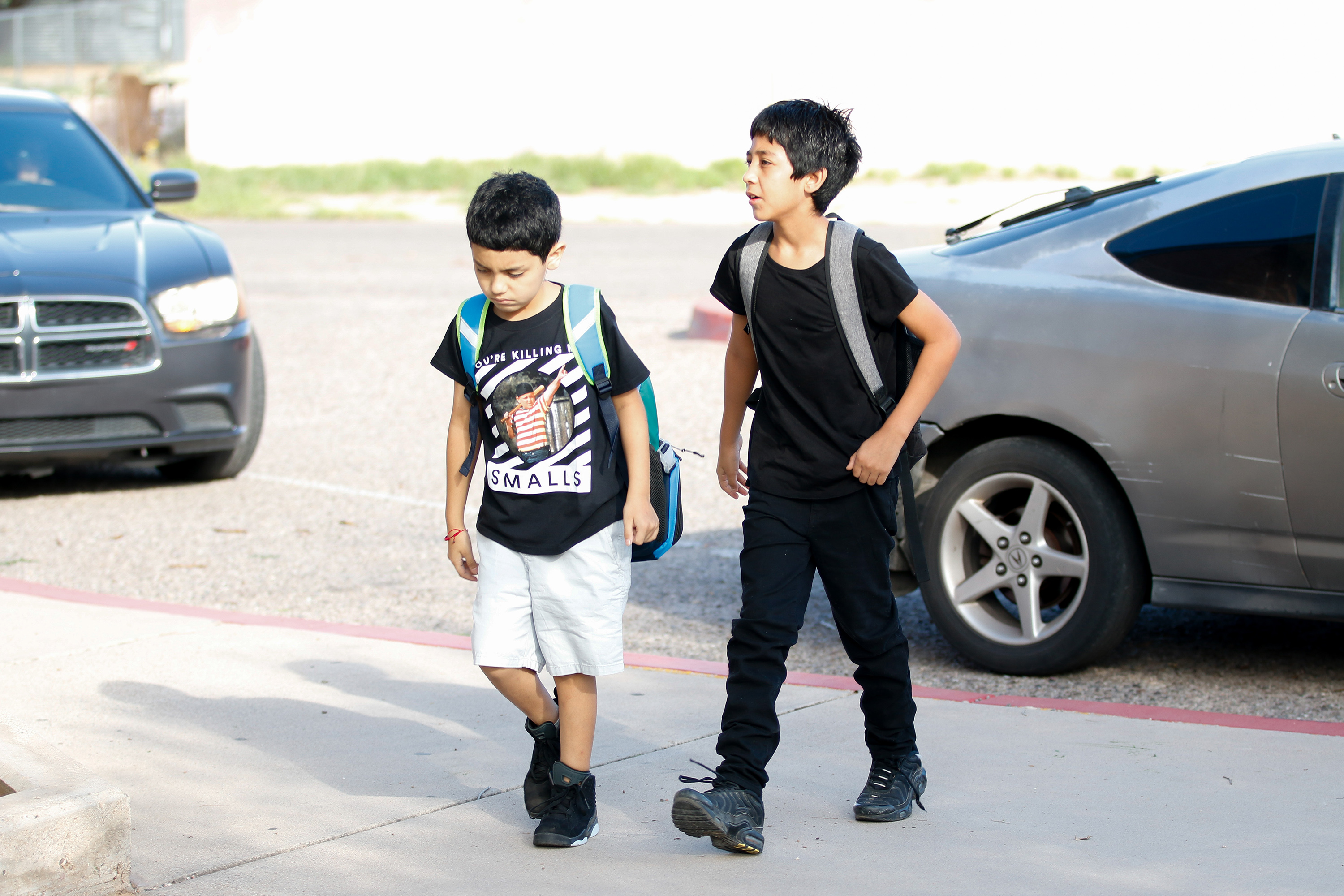 Two boys walk to school on the second day